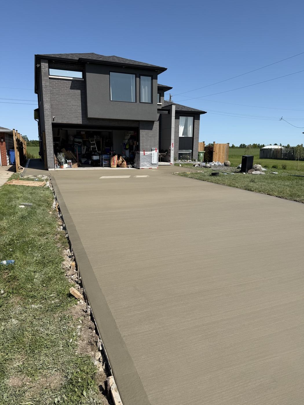 Fresh concrete driveway in front of a modern home